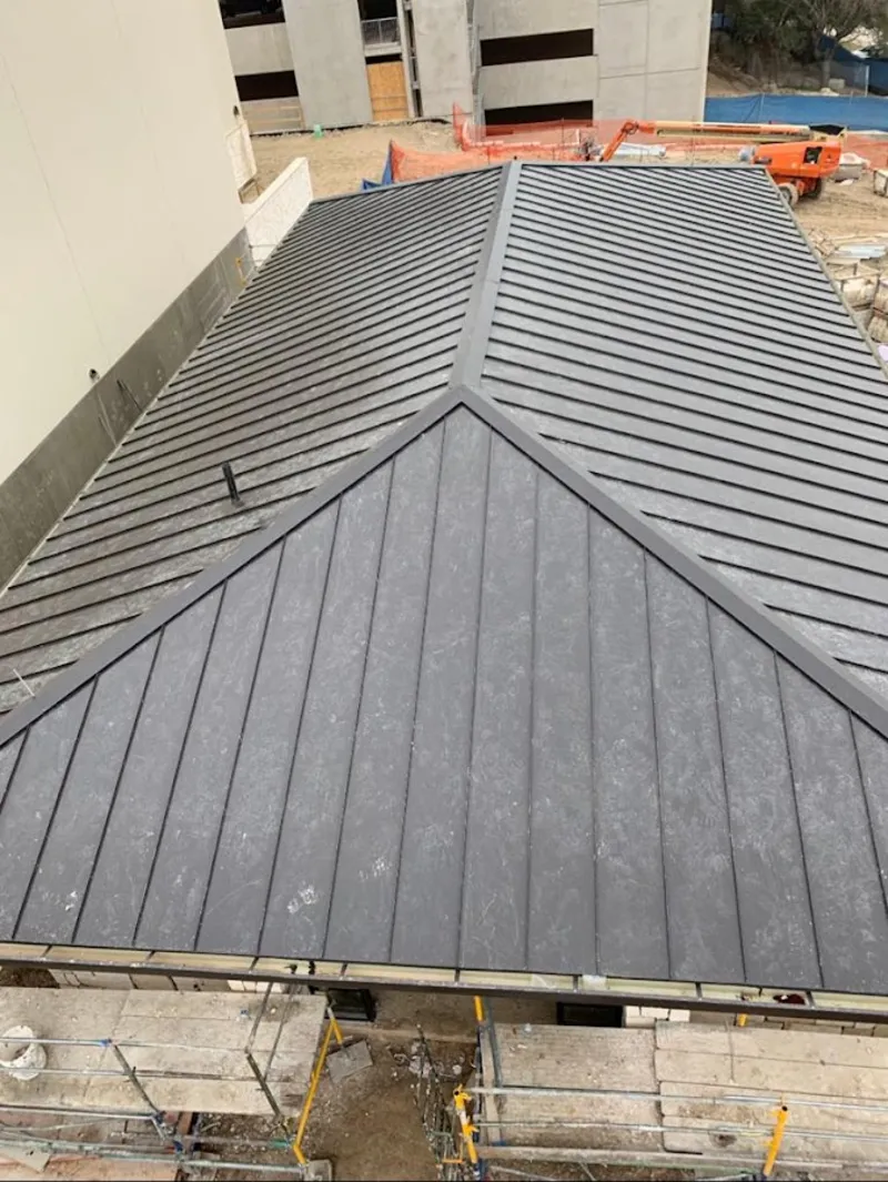 Commercial metal roof construction with crane equipment in Orange City